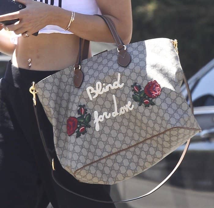 Flower embroidery and a "Blind for Love" print decorate Vanessa Hudgens Gucci tote from the Garden Souvenir Collection.