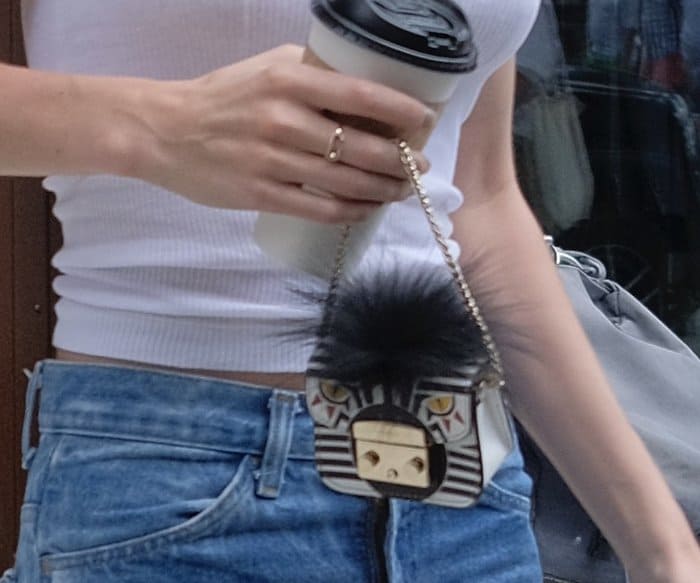 Model Gigi Hadid carrying a small Furla purse while walking around Manhattan.