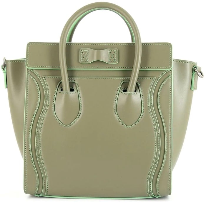 The green leather Celine luggage tote features two rounded top handles and a front stamped logo
